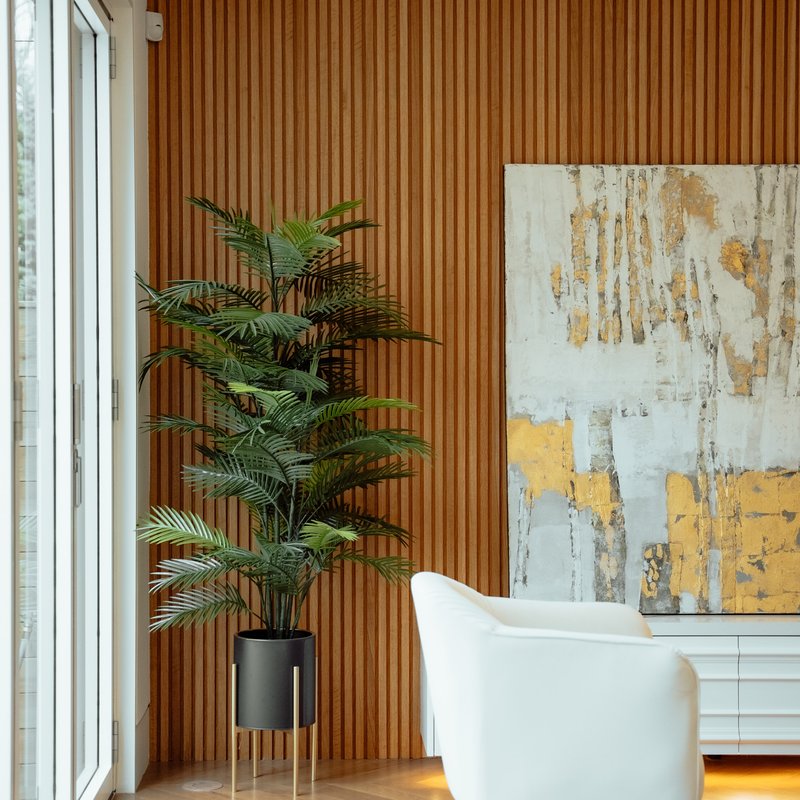 white chair in large room with wooden wall